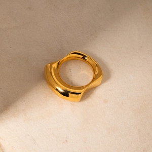 Detailed close-up of 18k gold-plated stainless steel ring with irregular wavy surface