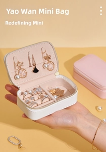 Close-up of portable PU leather jewelry organizer showing rings slots and necklace hooks