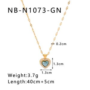 Macro shot of 18K gold heart pendant necklace with blue gemstone and dimensions detail