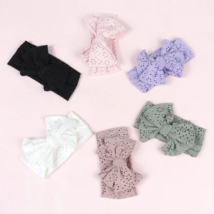 Set of six colorful knotted hollow bow baby headbands arranged in a circular flat lay
