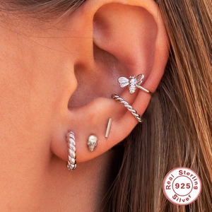 S925 sterling silver skull stud with diamonds and bee ear cuff on model's ear