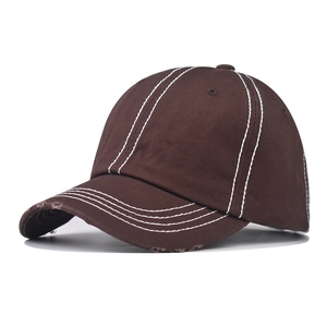 Detailed view of dark brown washed cotton baseball cap with white contrast stitching
