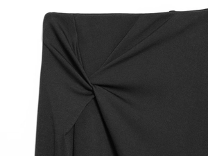 Detailed view of elegant black skirt featuring a side knot design and fine knit texture