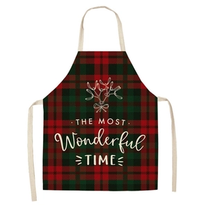Detail of red and green plaid apron featuring festive mistletoe and holiday text print