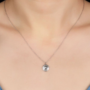 Close-up of S925 silver necklace with sparkling evil eye diamond pendant on model