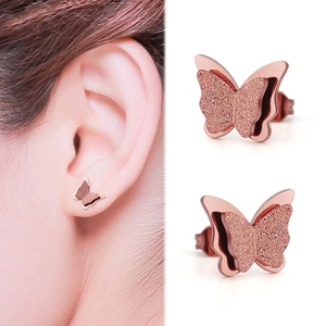 Detail view of butterfly stud earrings in rose gold finish with matte and polished texture
