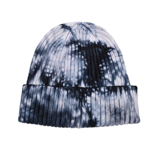 Detailed view of black and white tie-dye beanie featuring ribbed knit texture and folded cuff