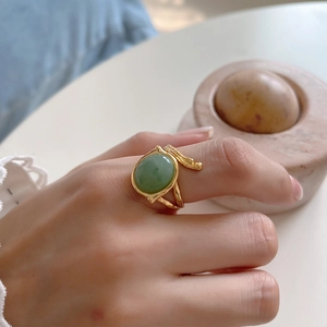 Elegant 925 sterling silver gold ring featuring an oval green agate gemstone on hand