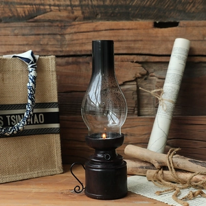Vintage kerosene lamp style resin candle holder with black metal base and glass cover
