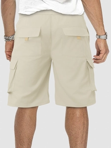 Rear view of light beige cargo shorts showing loose fit and functional back flap pocket