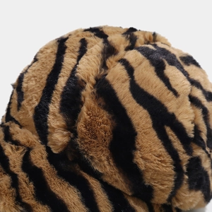 Detailed close-up of tiger stripe faux fur fabric on a warm plush winter baseball cap