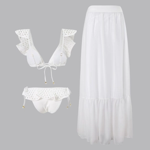 Detailed view of white three-piece beach set featuring eyelet embroidery and mesh skirt