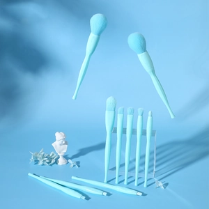 Artistic display of 10 light blue makeup brushes with fluffy bristles on acrylic stands