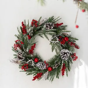Classic Christmas wreath with pine needles, red berries, cones and silver ornaments