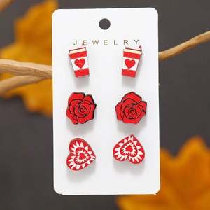 Three-piece wooden stud earring set featuring heart and rose designs on jewelry card