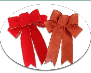 Close-up of red velvet and orange burlap Christmas bows with fine textured stitching