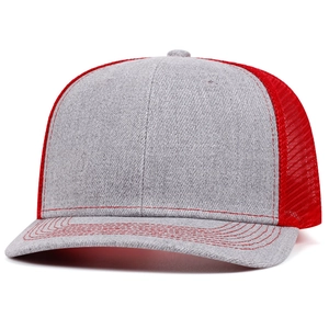 Close-up of grey cotton panel and red breathable mesh texture on the trucker cap