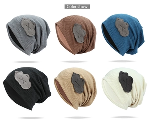 Detailed color show of six minimalist knitted slouchy beanies with cloud patch