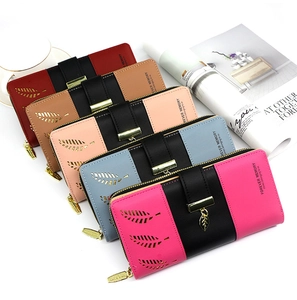 Five assorted long PU leather wallets featuring hollow leaf patterns and metal pendants