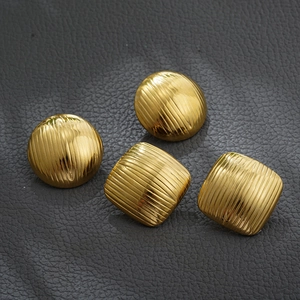Detailed close-up of 18K gold-plated geometric striped earrings with vintage texture