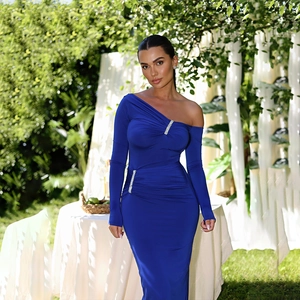 Detail showing side ruching and sparkling rhinestone buckle on blue one-shoulder dress