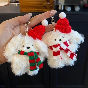 Cute white plush puppy keychains wearing red Christmas hats and festive knitted scarves