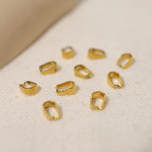 Macro detail of gold stainless steel U-shaped pendant clasps for DIY jewelry making