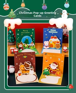 Set of 4 Christmas 3D pop-up cards with festive trees and Santa on wooden desk