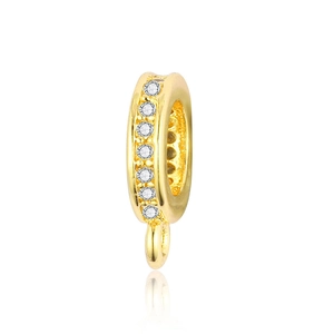 Macro shot of gold-plated pendant clasp with micro-set white cubic zirconia stones