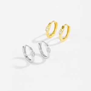 Close-up of S925 silver hoop earrings featuring sparkling teardrop zircon stones