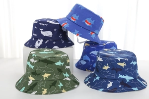 Detail view of five kids' sun hats with cartoon shark and ocean prints on cotton twill