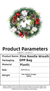 Detailed view of artificial pine wreath with pinecones, cotton balls and red berries