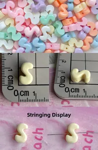 Detail view of mini macaron colorful S-letter resin beads with hole for DIY jewelry making