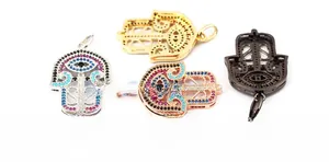 Macro view of 15mm Hamsa Hand pendants with multi-color zircon stones and scale reference