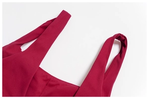 Detail of wide shoulder strap on dark red yoga bra showing high-quality stitching texture