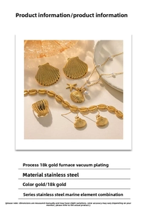 Detailed close-up of shell-shaped 18K gold plated stainless steel jewelry set on tray