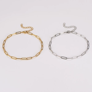 Detailed view of 18K gold and silver paper clip link chains on a clean white background
