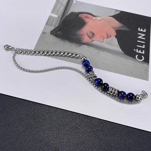 Detailed view of dual-layer stainless steel chain bracelet with blue tiger eye stone beads