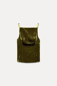 Close-up detail of green velvet camisole top showing the rich texture and fabric sheen