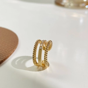 Chic twisted gold ear cuff with three layered bands and micro-set sparkling zircons