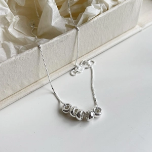 Minimalist s925 silver box chain necklace with six circular rings on white gift box