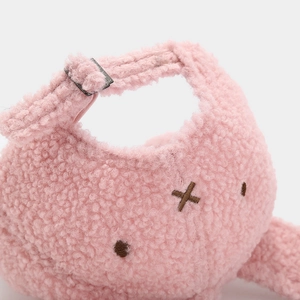Close-up of pink plush baseball cap with metal buckle and cute cartoon embroidery