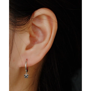 Close-up of S925 silver hoop earrings with black butterfly pendant and micro-set diamonds