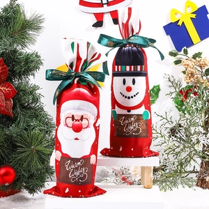 Christmas wine bottle covers featuring Santa and Snowman prints with satin ribbons
