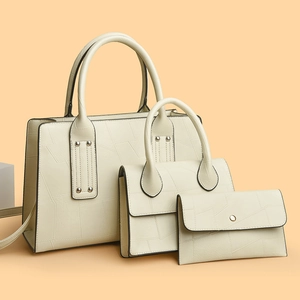 Three-piece beige faux leather handbag set with geometric embossed pattern and tote bag