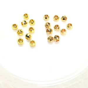 14K gold filled faceted spacer beads for jewelry making shown in a white bowl