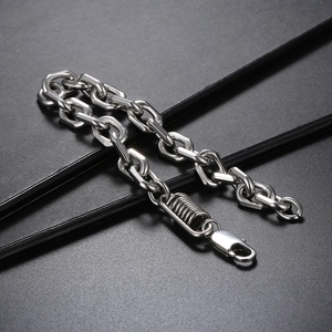 Macro detail of industrial silver stainless steel chain with lobster clasp and spring charm