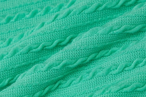 Primer plano detallado del tejido de punto de ochos verde menta de un vestido de otoño