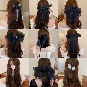 French mesh bow hair clip with pearls and tassels shown from multiple wearing angles