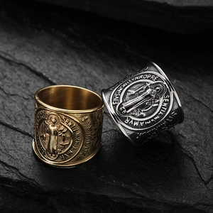 Saint Benedict exorcism ring in gold and silver finish on dark rock background